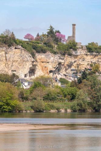 a village on a hill next to a river at Chambre de Charme dans maison d'hote "Le Petit Clouet" - Rochecorbon in Rochecorbon