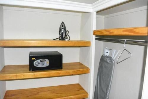 a closet with wooden shelves and a radio at The Bliss in Gros Islet