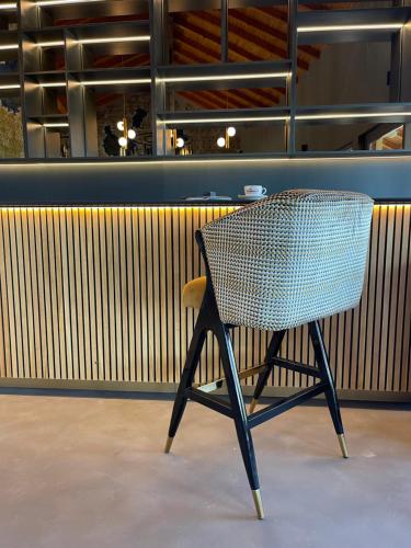 a wicker chair sitting in front of a restaurant at Pensiunea Casa Buna in Gîrbova