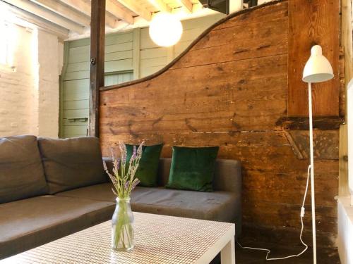 a living room with a couch and a table at Manor House Mews - rustic Stable Conversion in Dorchester