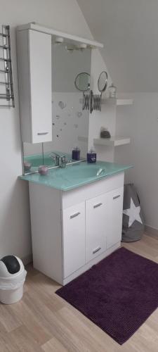 a bathroom with a counter with a sink and a mirror at Gite De La Baguelande in Les Andelys