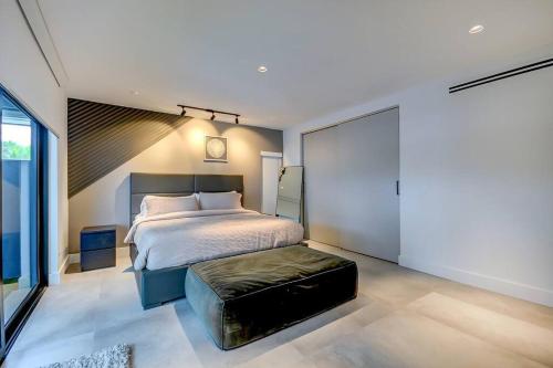 a bedroom with a bed and a stool in it at Stylish Haven Heated Pool Pool Table L28 in Cutler Bay