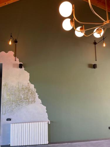 a wall with a painting of a city on it at Pensiunea Casa Buna in Gîrbova