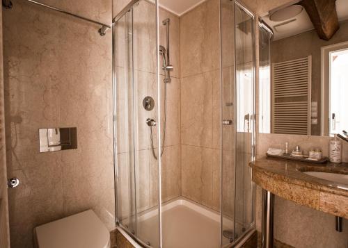 a bathroom with a shower and a sink at Hotel Nerudova 211 in Prague