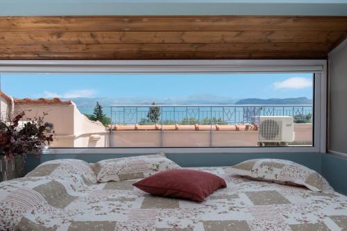 a bedroom with a bed and a large window at Beachfront Villa Samantha's Paradise in Kivérion