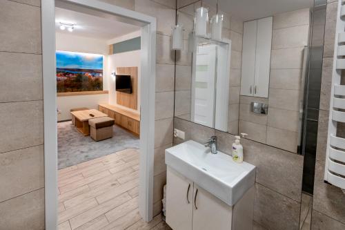 a bathroom with a sink and a toilet in a room at Apartament Błękitny in Kazimierz Dolny
