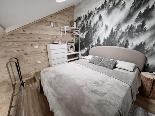 a bedroom with a bed and a wall with wood at Loft Malga Laghetto in Lavarone