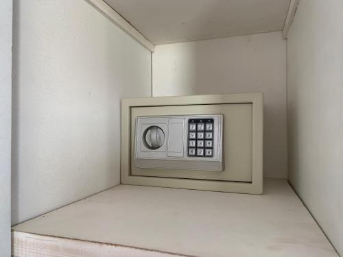 a microwave in the corner of a room at PortghalibFlat in Port Ghalib