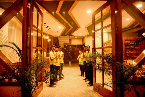 a group of people standing in a room with plants at The Abhyudyam Ganga in Haridwār