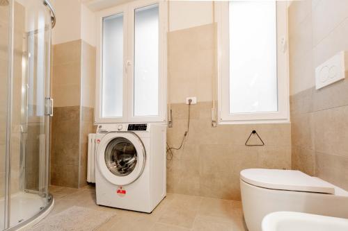 La salle de bains est pourvue d'un lave-linge et de toilettes. dans l'établissement Realkasa Amendola Apartment, à Bologne