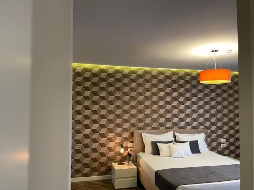 a bedroom with a bed with a headboard at Light Hotel in Tirana