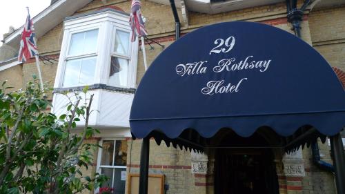 a building with a sign on the front of it at Villa Rothsay Hotel in Cowes