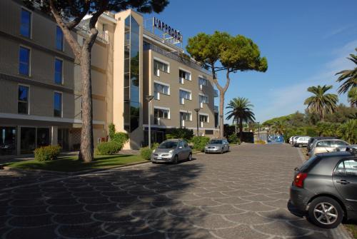 a parking lot with cars parked in front of a building at Grand Hotel L'Approdo in Terracina