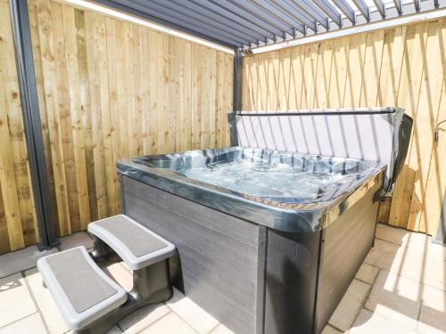 a hot tub in a room with a toilet at Seascape Villa in Filey
