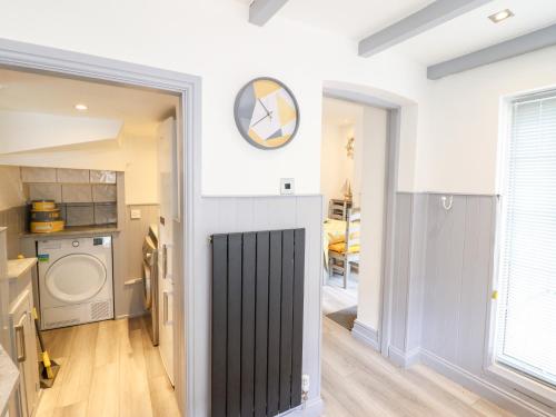 a kitchen and living room with a washer and dryer at Owen Villa in Llandudno