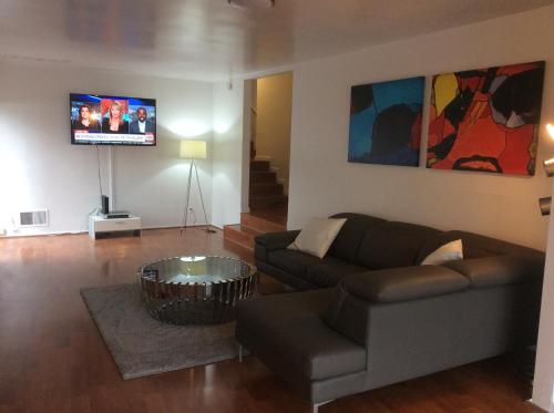 a living room with a couch and a tv at 5 bedroom 3 bath home near universal in Sherman Oaks