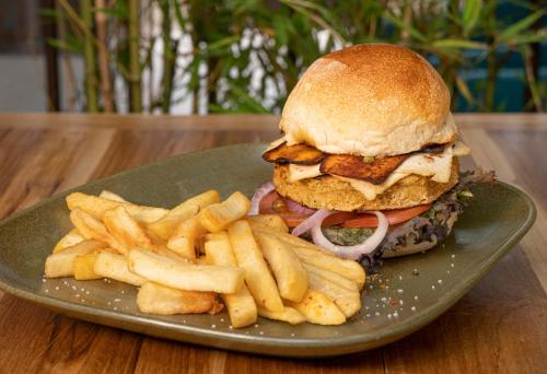 a plate with a sandwich and french fries on a table at Hotel Boutique El Carmel in Villa de Leyva