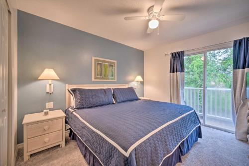 a bedroom with a blue bed and a window at Family-Friendly Lake Berkeley Resorts Home! in Kissimmee