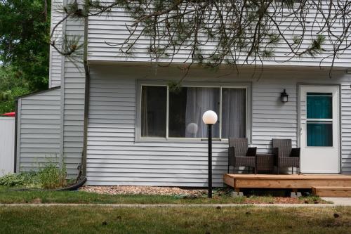 a house with a bench in front of a window at Idlewild Pines Retreat in Rapid City