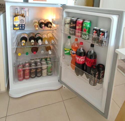 an open refrigerator filled with lots of drinks and soda at Altos San Martín in Concepción del Uruguay