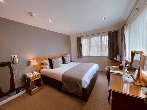 a hotel room with a large bed and a window at La Barbarie Hotel in St Martin Guernsey
