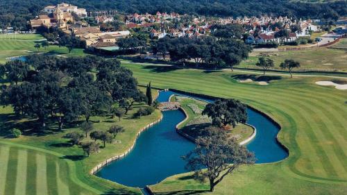 an aerial view of a golf course with a river at AIRE DE SOTOGRANDE in Sotogrande