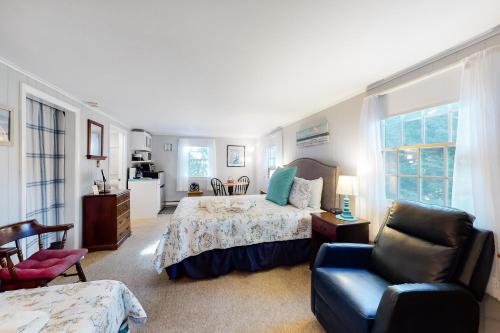 a bedroom with a bed and a chair at Beach Rose Guest Studio in Nauset Heights