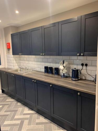 a kitchen with black cabinets and a counter top at Pleasure Beach View in Blackpool