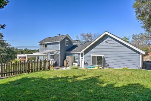 a house with a fence in front of a yard at Sierra Sunset Inn - 3 Miles to Placerville! in Placerville