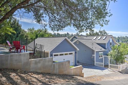a blue house with a garage and a red chair at Sierra Sunset Inn - 3 Miles to Placerville! in Placerville