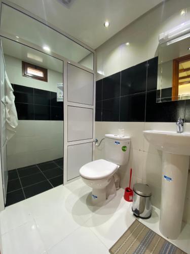 a bathroom with a toilet and a sink and a shower at Kasbah Roseville in Ait Sedrate Sahl Gharbia