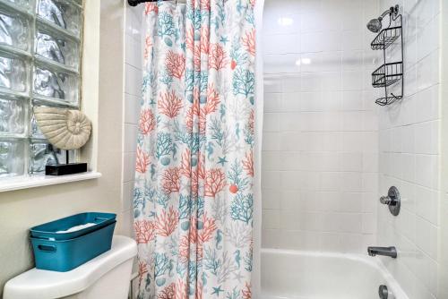 a bathroom with a shower curtain and a toilet at St Pete Bungalow Less Than 2 Mi to Beach and Downtown! in St Petersburg