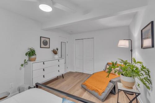 a white bedroom with a bed and a dresser at Spacious 3-Bedroom Bungalow in Bradley Beach in Bradley Beach