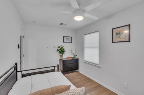 a white bedroom with a bed and a window at Spacious 3-Bedroom Bungalow in Bradley Beach in Bradley Beach