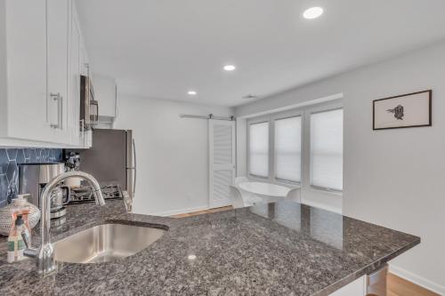 a kitchen with a sink and a granite counter top at Spacious 3-Bedroom Bungalow in Bradley Beach in Bradley Beach
