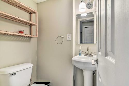 a bathroom with a sink and a toilet and a mirror at Pet-Friendly Home, 5 Mi to State Park with Lake in Four Towns