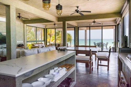 a kitchen and dining room with a view of the ocean at Casa Gonza Holbox in Holbox Island
