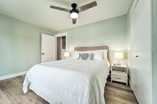 a bedroom with a white bed and a ceiling fan at Cherokee Lake Home with Private Dock and Patio! in Bean Station