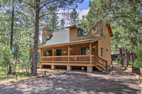 a log home with a large deck in the woods at 2 Mi to Fool Hollow Lake Wooded Cabin with Fire Pit in Show Low