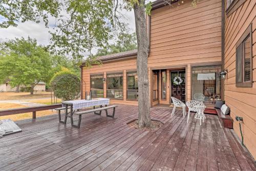 a wooden deck with a table and chairs on a house at Bryan Home with Deck and Yard about 4 Mi to Texas A and M! in Bryan