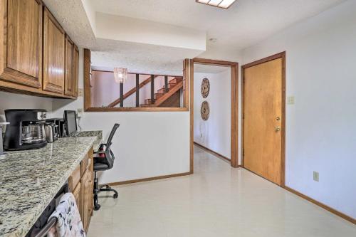 a kitchen with a counter top and a hallway at Bryan Home with Deck and Yard about 4 Mi to Texas A and M! in Bryan
