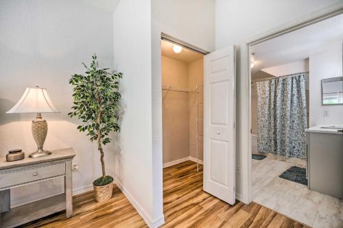 a bathroom with a door and a plant in a room at Kissimmee Condo Community Perks, 10 Mi to Disney! in Kissimmee