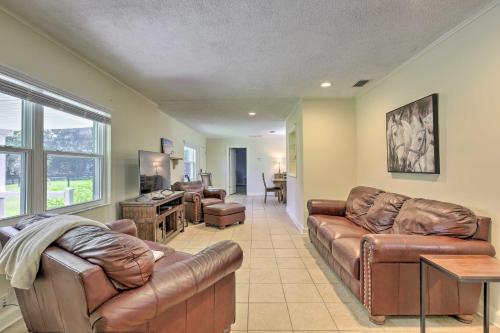 a living room with two leather couches and a kitchen at Pet-Friendly Home Close to WEC Ocala! in Ocala