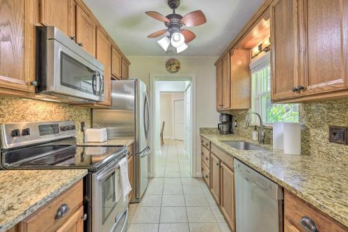 a kitchen with wooden cabinets and stainless steel appliances at Pet-Friendly Home Close to WEC Ocala! in Ocala