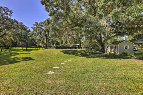 a large grass field with trees and a house at Pet-Friendly Home Close to WEC Ocala! in Ocala