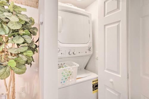 a laundry room with a washer and dryer at Heated Saltwater Pool and Bar Del Ray Cottage! in Delray Beach
