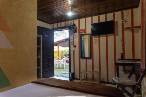 Una cama o camas en una habitación de Pousada Recanto das Cores