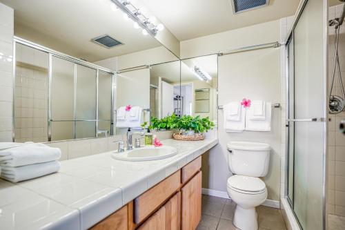 a bathroom with a sink and a toilet and a shower at Kauai Beach Villas E5 in Lihue