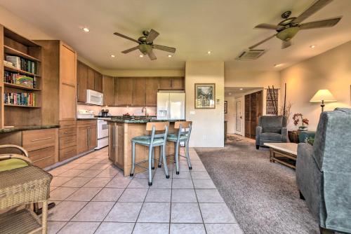 a kitchen and living room with two ceiling fans at Gorgeous Oceanfront Kihei Condo with Balcony! in Wailea