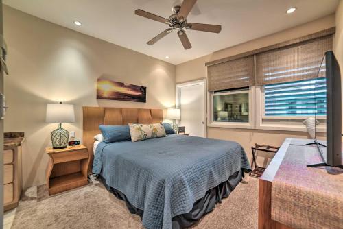 a bedroom with a bed and a ceiling fan at Gorgeous Oceanfront Kihei Condo with Balcony! in Wailea
